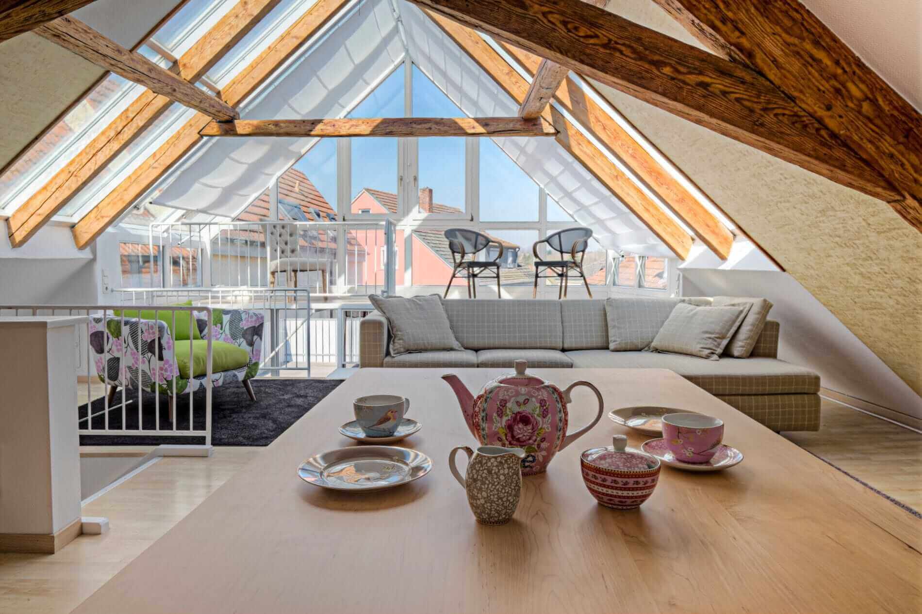 A bright, glazed loft conversion with a pitched roof in a modern home.